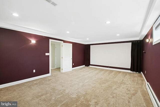 home theater room with a baseboard heating unit, baseboards, visible vents, and carpet floors