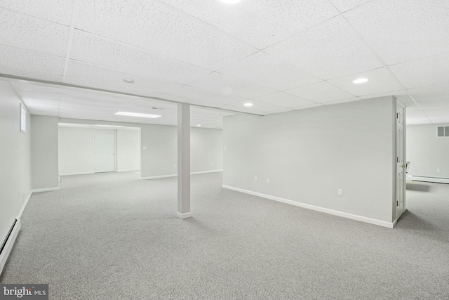 finished basement with visible vents, a baseboard radiator, baseboards, and carpet floors