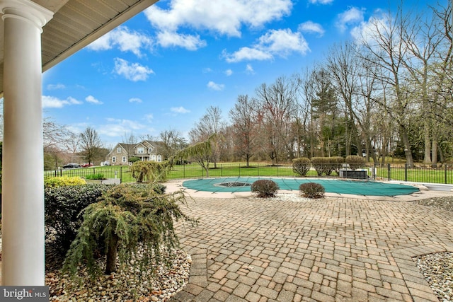 view of swimming pool with a patio, a yard, a fenced in pool, and fence