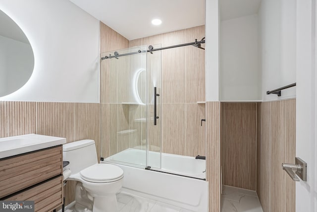 1143 Tasker St, Philadelphia, PA 19148 - full bath featuring a wainscoted wall, toilet, marble finish floor, combined bath / shower with glass door, and vanity