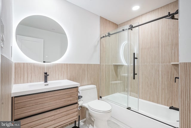 1143 Tasker St, Philadelphia, PA 19148 - full bath featuring wainscoting, toilet, vanity, and shower / bath combination with glass door