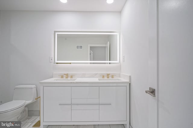 1143 Tasker St, Philadelphia, PA 19148 - bathroom with visible vents, a sink, double vanity, and toilet