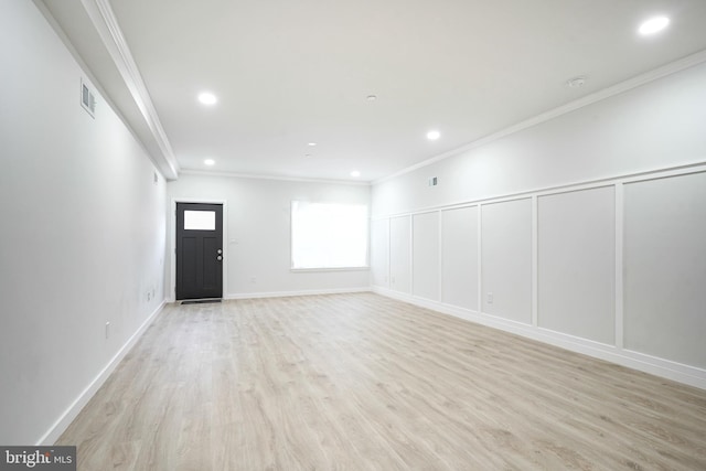 1143 Tasker St, Philadelphia, PA 19148 - unfurnished living room featuring recessed lighting, light wood finished floors, visible vents, a decorative wall, and crown molding