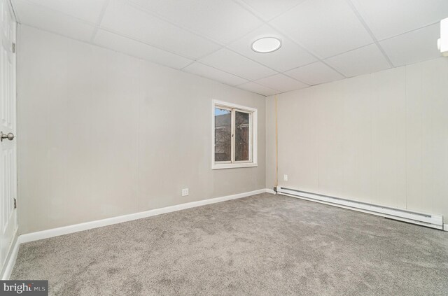 606 N St, Lykens, PA 17048 - spare room featuring baseboard heating, baseboards, a drop ceiling, and carpet