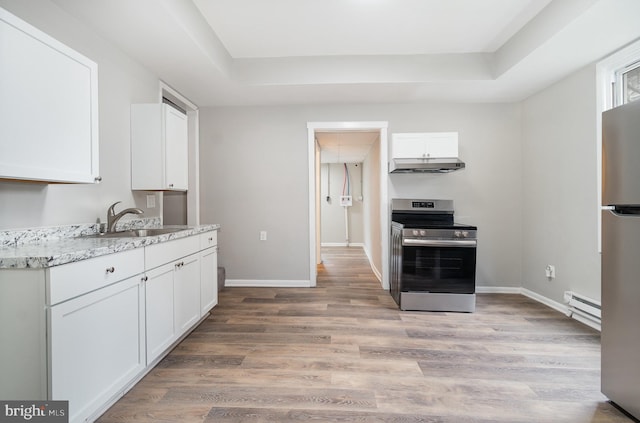 606 N St, Lykens, PA 17048 - kitchen with a baseboard radiator, white cabinetry, appliances with stainless steel finishes, and under cabinet range hood