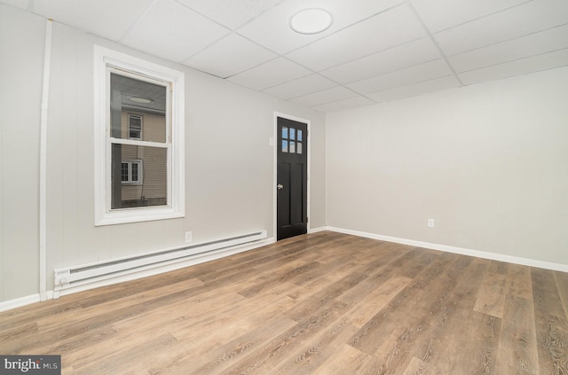 606 N St, Lykens, PA 17048 - unfurnished room featuring a baseboard radiator, baseboards, wood finished floors, and a paneled ceiling