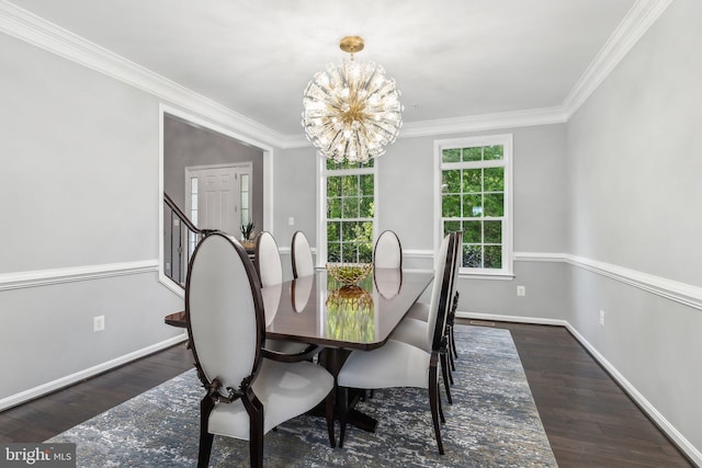 dining area with crown molding, baseboards, wood finished floors, and a notable chandelier