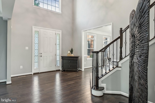 entryway featuring baseboards, a high ceiling, and hardwood / wood-style flooring