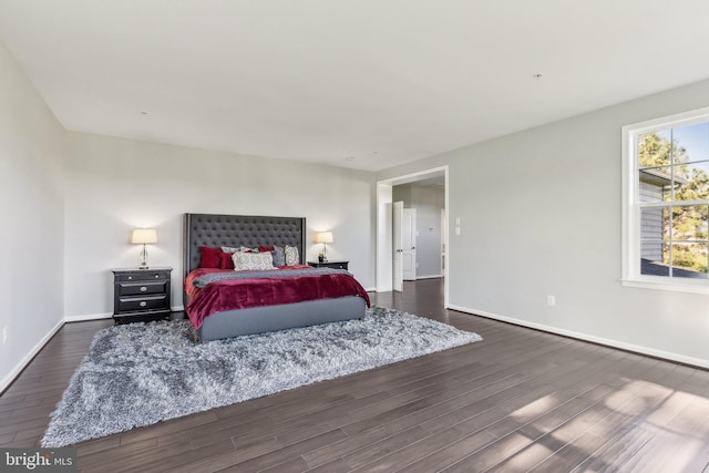 bedroom featuring dark wood-type flooring and baseboards