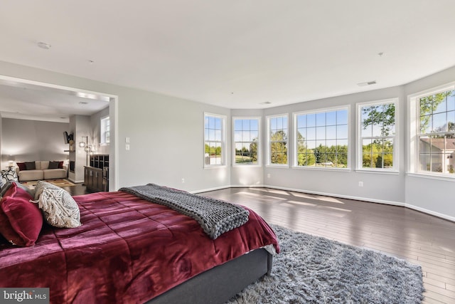 bedroom featuring baseboards, visible vents, and hardwood / wood-style flooring