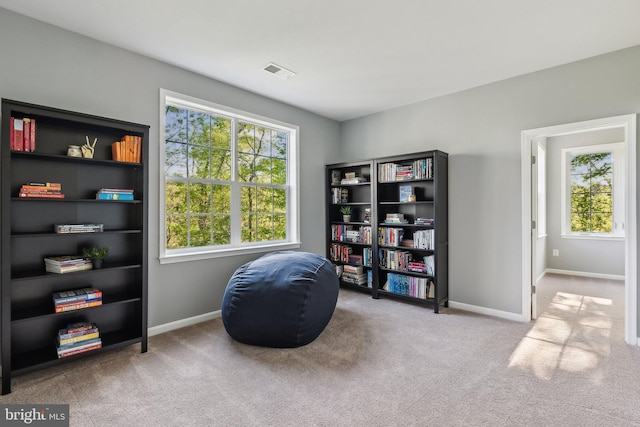 living area with baseboards, carpet flooring, and visible vents