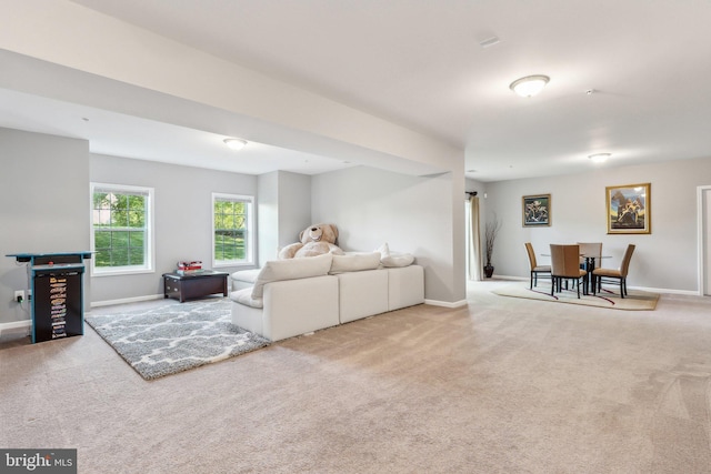 carpeted living area with baseboards