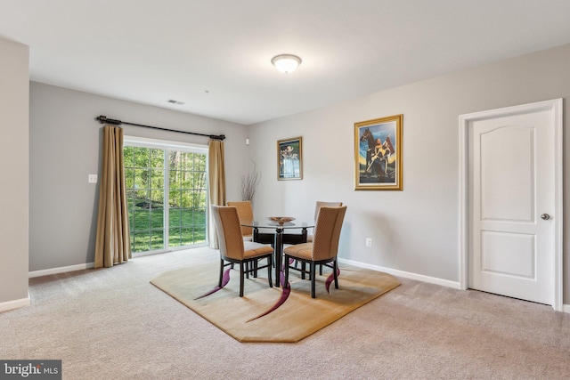 dining area with baseboards, carpet flooring, and visible vents