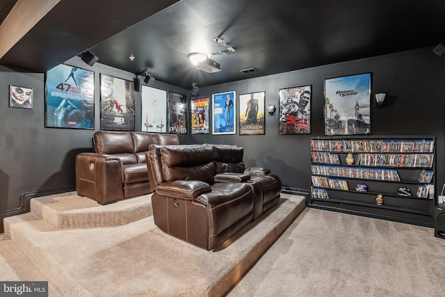 carpeted home theater room featuring baseboards