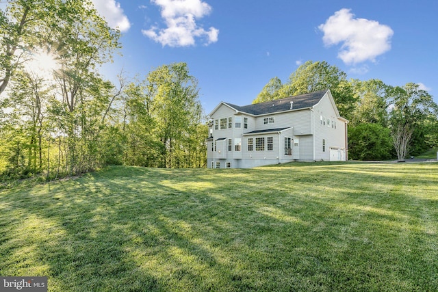 rear view of property with a yard