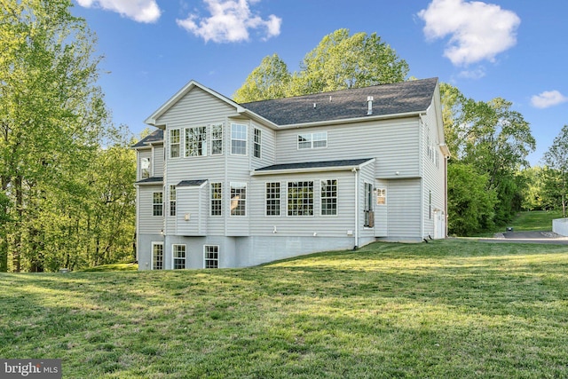 back of property with a lawn