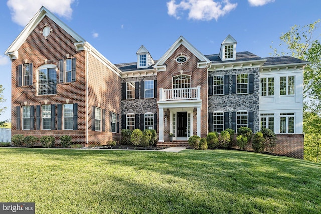 colonial-style house featuring stone siding, a front lawn, and brick siding