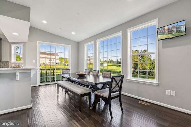 dining area with baseboards, vaulted ceiling, dark wood finished floors, and visible vents