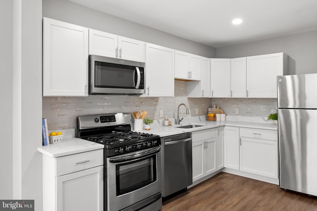 4319 Valley View Ave, Baltimore, MD 21206 - kitchen featuring white cabinets, decorative backsplash, appliances with stainless steel finishes, and a sink
