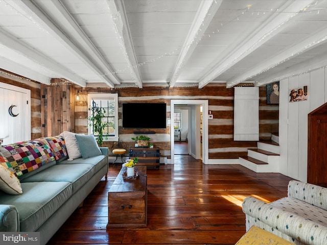 living room featuring beamed ceiling, wooden walls, and wood-type flooring