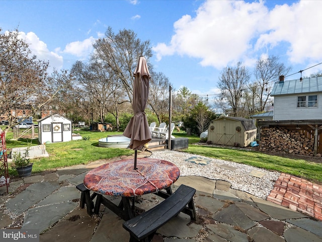 view of patio / terrace featuring an outdoor structure and a shed