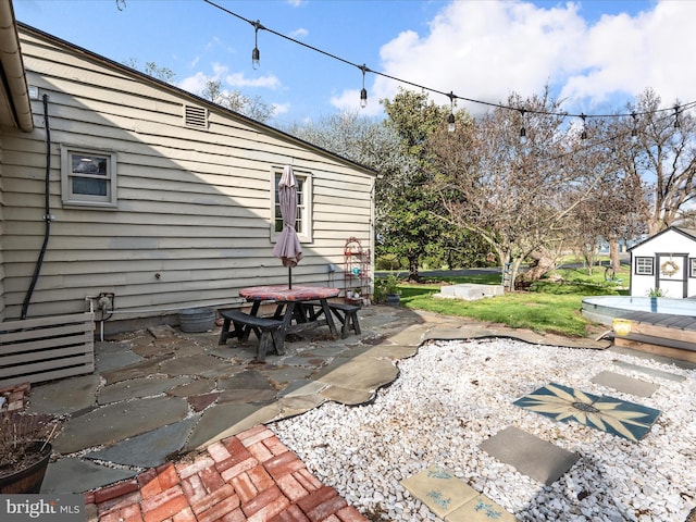 view of yard with a storage shed, a patio area, and an outdoor structure
