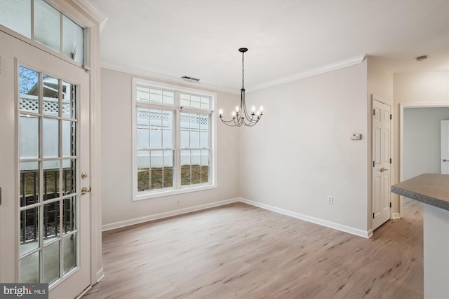 unfurnished dining area with an inviting chandelier, light wood finished floors, and baseboards