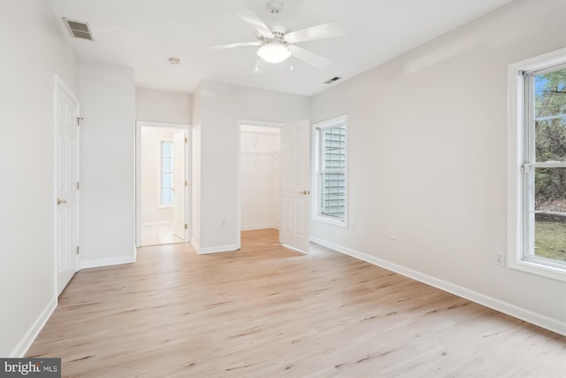 unfurnished bedroom featuring baseboards, light wood-style floors, and visible vents
