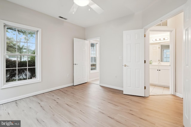 unfurnished bedroom featuring visible vents, light wood finished floors, and baseboards