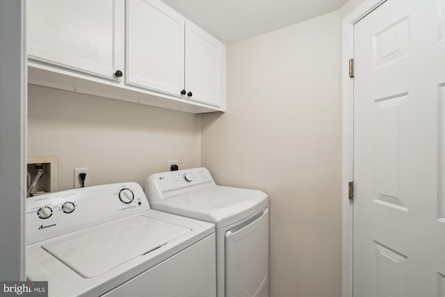 laundry room with separate washer and dryer and cabinet space