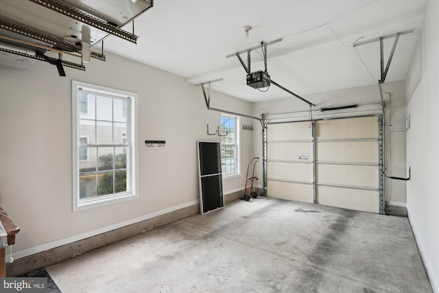 garage with a garage door opener and baseboards