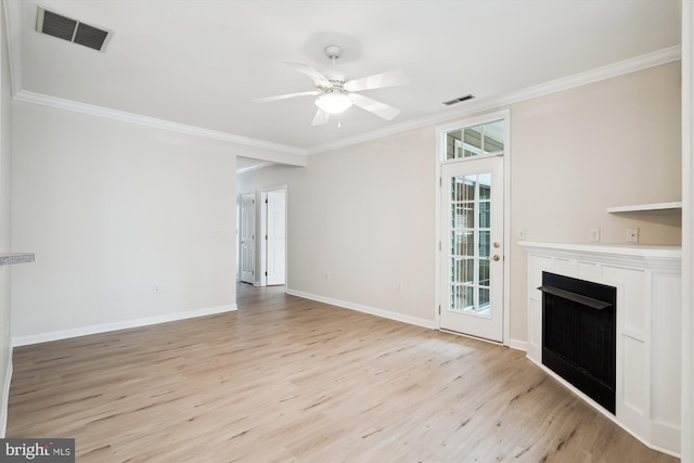 unfurnished living room featuring light wood-type flooring, visible vents, and crown molding