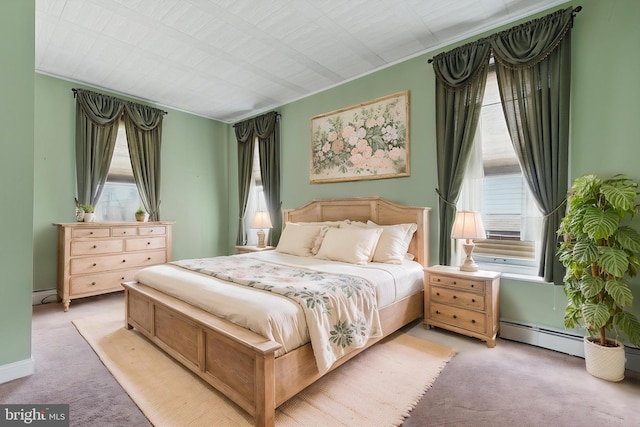 carpeted bedroom with a baseboard radiator