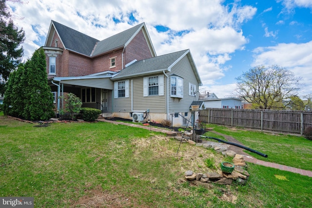 back of house featuring a yard, ac unit, and fence
