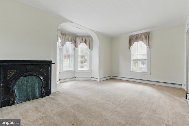 unfurnished living room featuring carpet flooring, baseboard heating, and crown molding