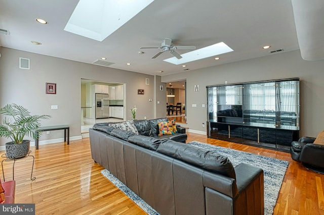 3820 Lorcom Ln, Arlington, VA 22207 - living room with a ceiling fan, light wood-style flooring, visible vents, and a skylight