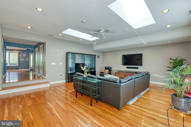 3820 Lorcom Ln, Arlington, VA 22207 - living area with recessed lighting, light wood finished floors, a skylight, and baseboards