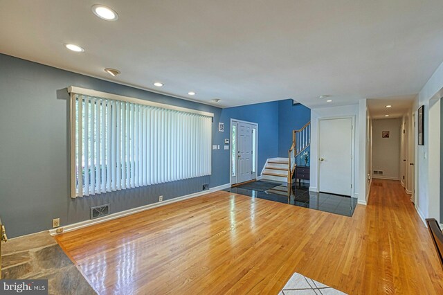 3820 Lorcom Ln, Arlington, VA 22207 - unfurnished living room with visible vents, recessed lighting, and stairway