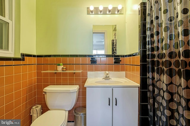 3820 Lorcom Ln, Arlington, VA 22207 - bathroom with curtained shower, toilet, vanity, tile walls, and wainscoting
