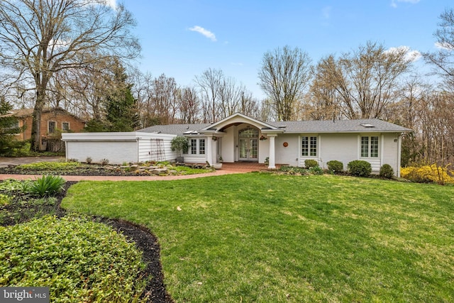 ranch-style house with french doors, a front lawn, and roof with shingles