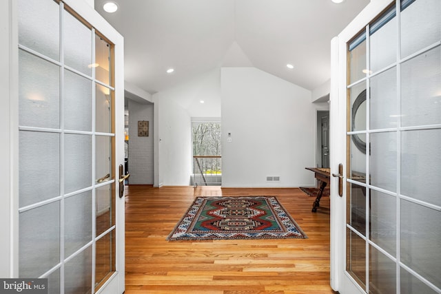 interior space featuring recessed lighting, french doors, wood finished floors, and lofted ceiling