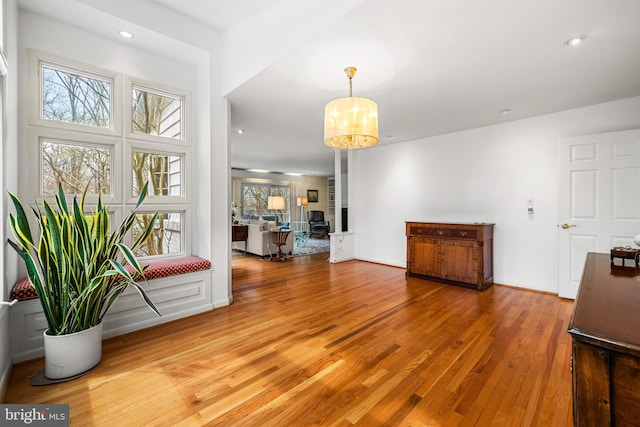 interior space with recessed lighting, a notable chandelier, light wood-style floors, and baseboards