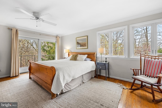 bedroom with ornamental molding, baseboards, access to outside, and wood finished floors