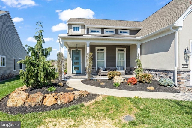 1205 Mosaic Dr, Lebanon, PA 17042 - view of front facade featuring a porch, stone siding, stucco siding, a front lawn, and roof with shingles