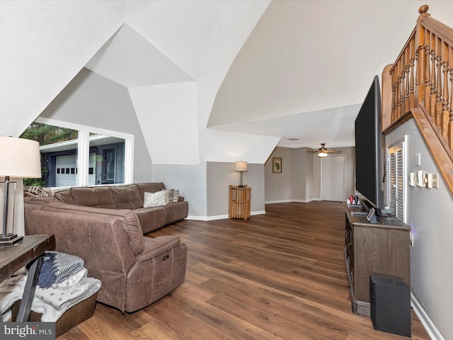 living area with baseboards, a ceiling fan, wood finished floors, and vaulted ceiling