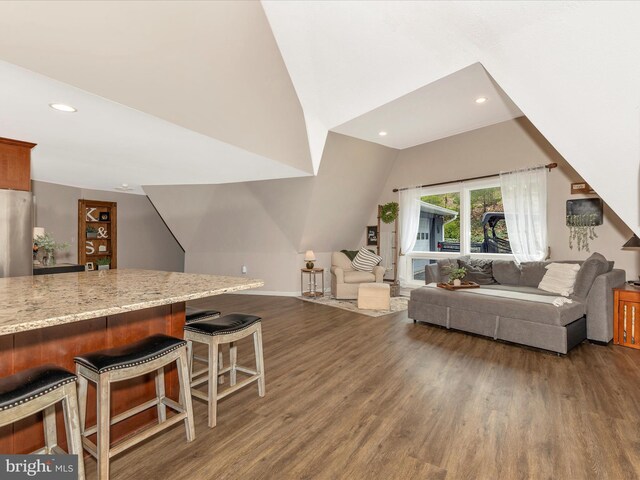 living area featuring recessed lighting, wood finished floors, and baseboards