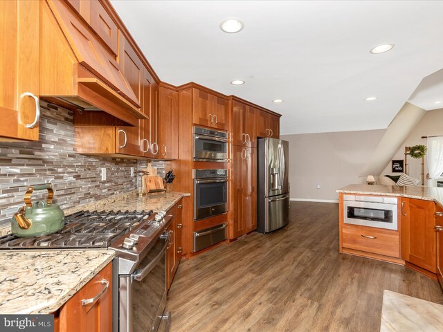 kitchen with dark wood-style floors, stainless steel appliances, extractor fan, a warming drawer, and tasteful backsplash