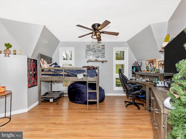 bedroom featuring light wood-type flooring, baseboards, and multiple windows