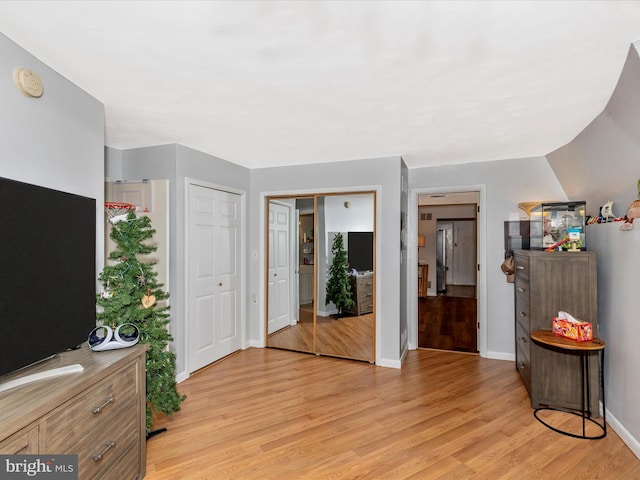 foyer entrance with baseboards and light wood-style flooring
