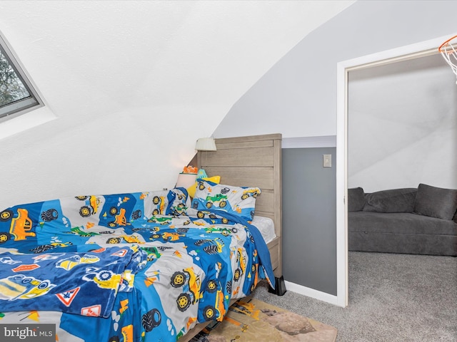 carpeted bedroom with vaulted ceiling and baseboards